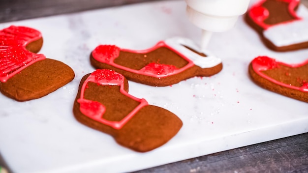 Step by step. Decorating gingerbread and sugar cookies with royal icing for Christmas.