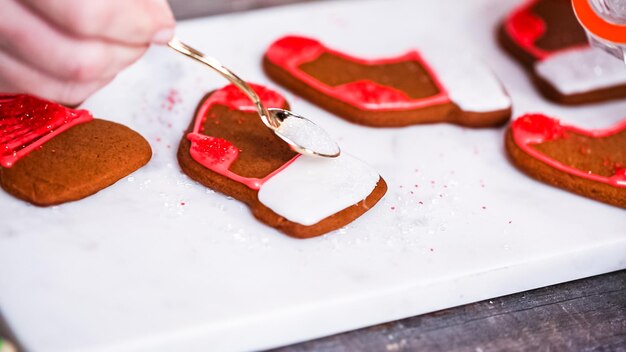 Step by step. Decorating gingerbread and sugar cookies with royal icing for Christmas.