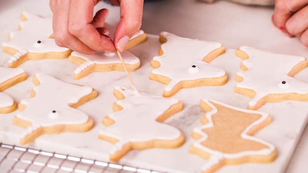 Photo step by step. decorating unocrn shaped sugar cookies with royal icing for little girl birthday party.