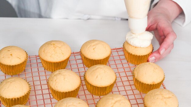 Step by step. Decorating vanilla cupcakes with white buttercream frosting for Easter.