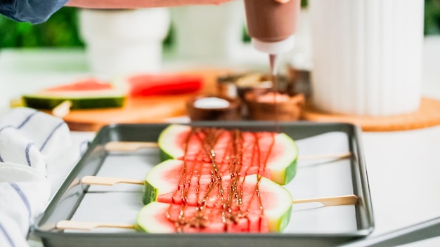 Step by step. Drizzling chocolate on watermelon ice pops.