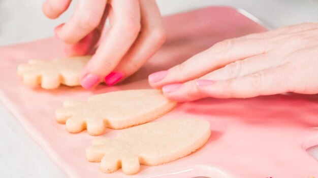 Step by step. Flat lay. Decorating Easter sugar cookies with rotal icing.