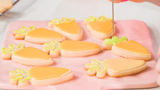 Step by step. Flat lay. Decorating Easter sugar cookies with rotal icing.