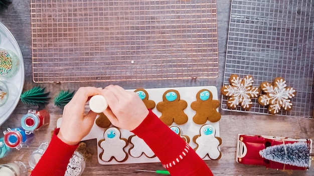 Step by step. Flat lay. Decorating gingerbread cookies with royal icing.