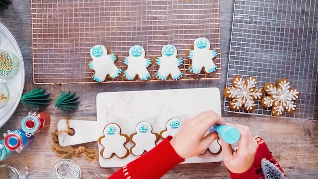 Step by step. Flat lay. Decorating gingerbread cookies with royal icing.