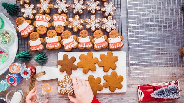 Step by step. Flat lay. Decorating gingerbread cookies with royal icing.