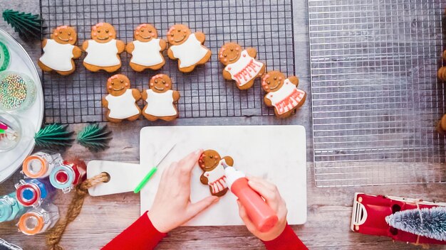 Step by step. Flat lay. Decorating gingerbread cookies with royal icing.