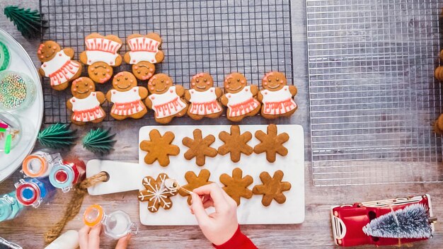 Step by step. Flat lay. Decorating gingerbread cookies with royal icing.