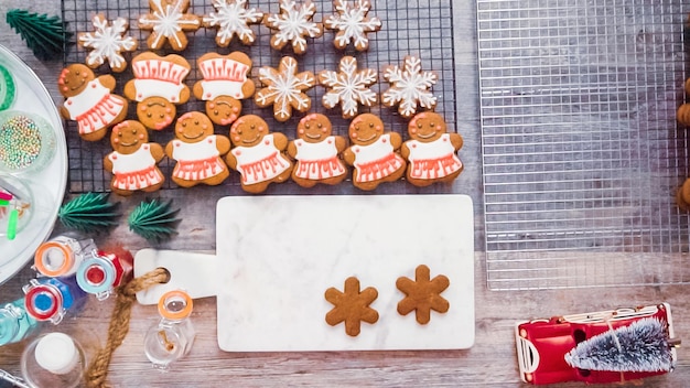 Step by step. flat lay. decorating gingerbread cookies with royal icing