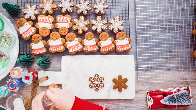 Step by step. Flat lay. Decorating gingerbread cookies with royal icing.