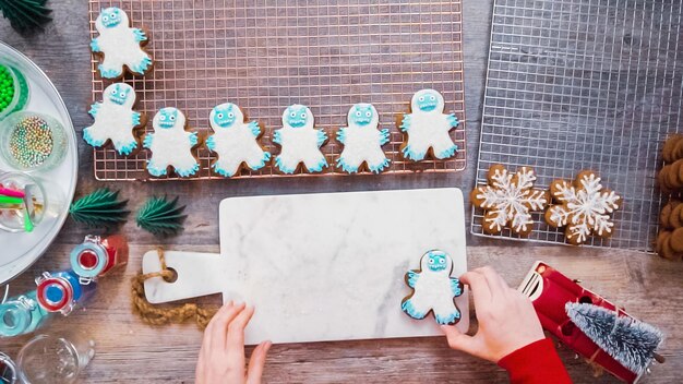 Step by step. Flat lay. Decorating gingerbread cookies with royal icing.