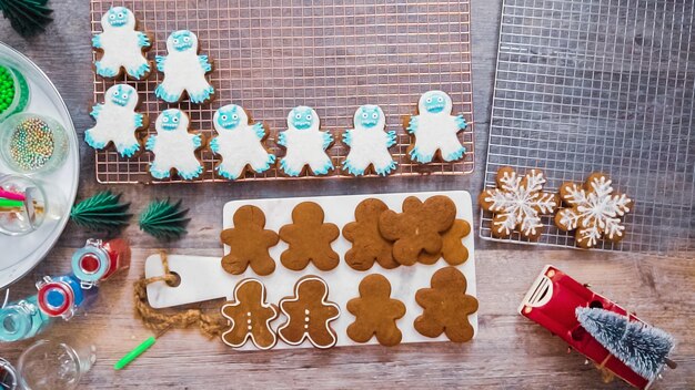 Step by step. Flat lay. Decorating gingerbread cookies with royal icing.