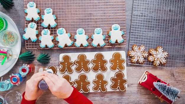 Step by step. Flat lay. Decorating gingerbread cookies with royal icing.