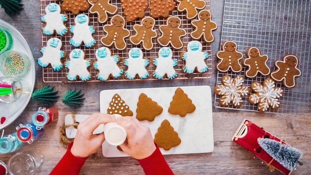 Step by step. Flat lay. Decorating gingerbread cookies with royal icing.