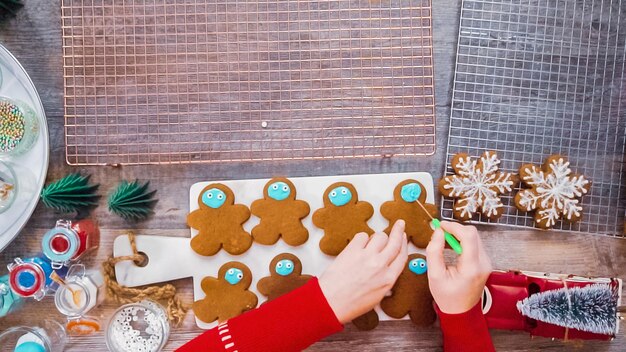 Step by step. Flat lay. Decorating gingerbread cookies with royal icing.