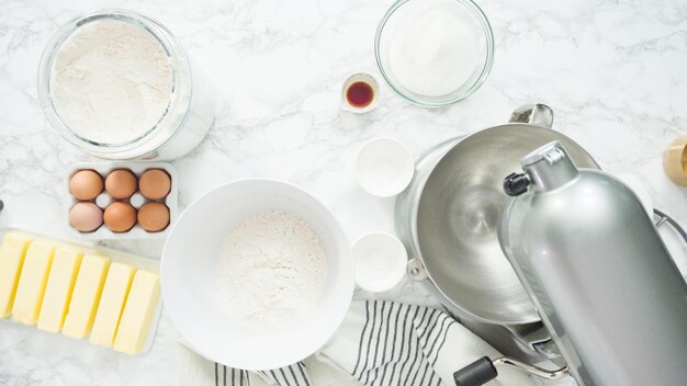 Step by step. Flat lay. Mixing ingredients in standing kitchen mixer to bake sugar cookies.