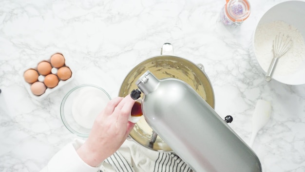 Step by step. Flat lay. Mixing ingredients in standing kitchen mixer to bake sugar cookies.