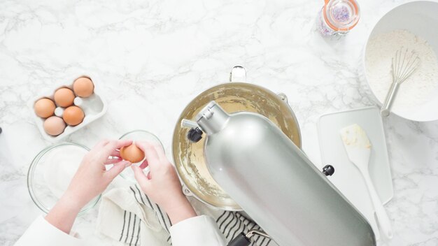 Step by step. Flat lay. Mixing ingredients in standing kitchen mixer to bake sugar cookies.