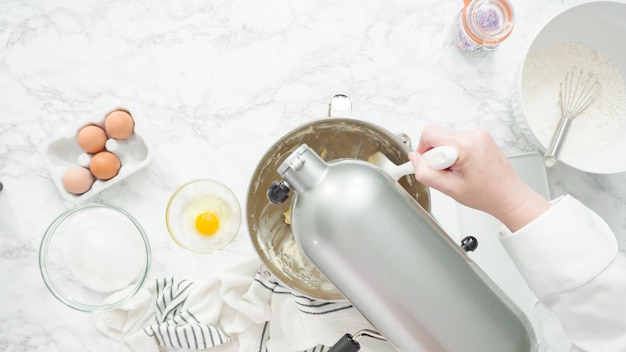 Step by step. Flat lay. Mixing ingredients in standing kitchen mixer to bake sugar cookies.