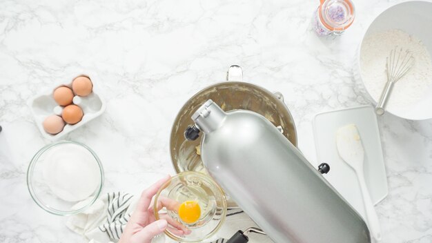 Step by step. Flat lay. Mixing ingredients in standing kitchen mixer to bake sugar cookies.