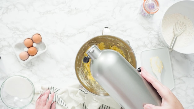 Step by step. Flat lay. Mixing ingredients in standing kitchen mixer to bake sugar cookies.