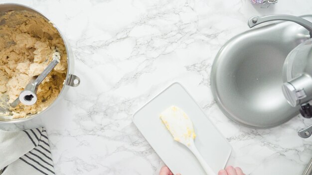 Step by step. Flat lay. Mixing ingredients in standing kitchen mixer to bake sugar cookies.