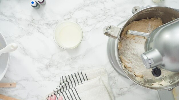 Step by step. Flat lay. Mixing ingredients in standing kitchen mixer to bake a three-layer vanilla cake.