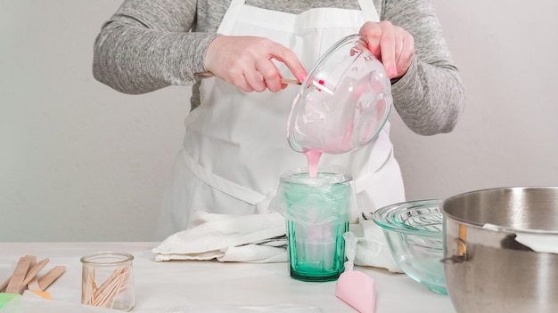 Step by step. Flat lay. Mixing royal icing to decorate Easter sugar cookeis.