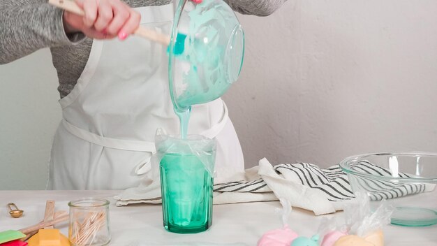 Step by step. Flat lay. Mixing royal icing to decorate Easter sugar cookeis.