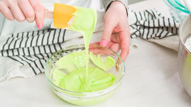 Step by step. Flat lay. Mixing royal icing to decorate Easter sugar cookeis.