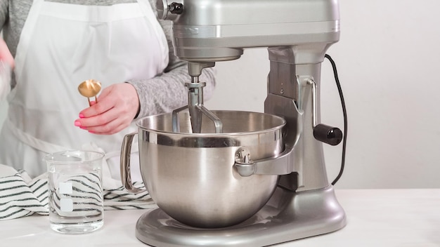 Step by step. Flat lay. Mixing royal icing in electric kitchen mixer for Easter cookies.