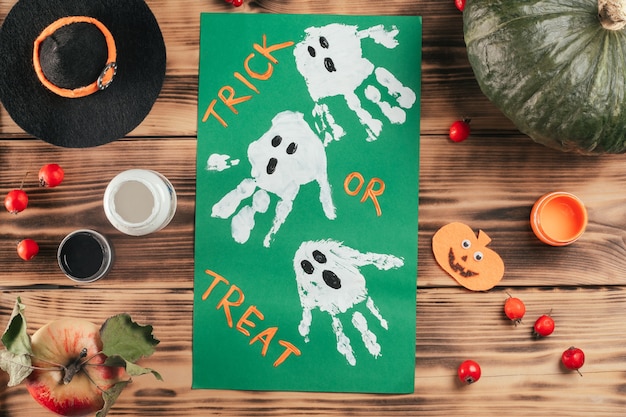 Step-by-step Halloween tutorial ghosts child's handprint. Step 10: Add Trick or Treat, or whatever you like. Top view