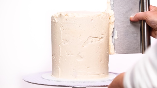 step by step. icing tall birthday cake with white buttercream icing.