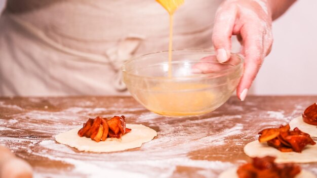 Step by step. Making home made empanadas with red apples fillings.