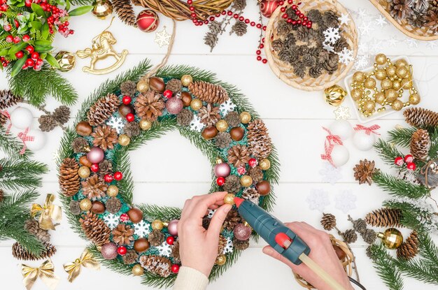 Step by step making a large Christmas wreath, step 16 - glue gold beads on hot glue