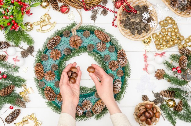 Step-by-step making of a large Christmas wreath, step 9 - take chestnuts