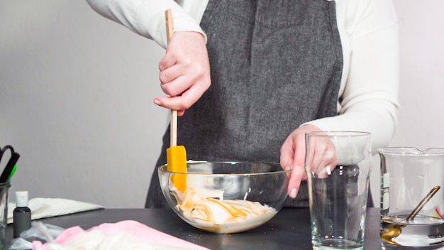 Step by step. Mixing in food coloring into the royal icing to decorate sugar cookies.