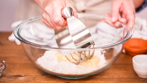 Step by step. Mixing ingredients to make dough for empanadas.