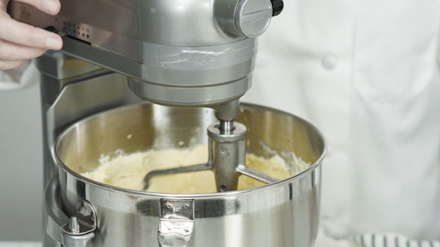 Step by step. Mixing ingredients in standing kitchen mixer to bake sugar cookies.