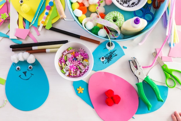 Photo step by step. mother and daughter decorating paper easter eggs.