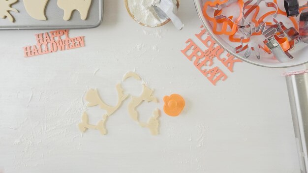 Step by step. Mother and daughter maaking Halloween sugar cookies.