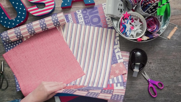 Step by step. Mother and daughter making paper firecrackers for July 4th celebration.