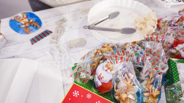 Step by step. Packaging homemade fudge and cookies into a Christmas gift box.