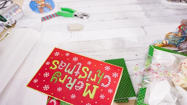 Step by step. Packaging homemade fudge and cookies into a Christmas gift box.