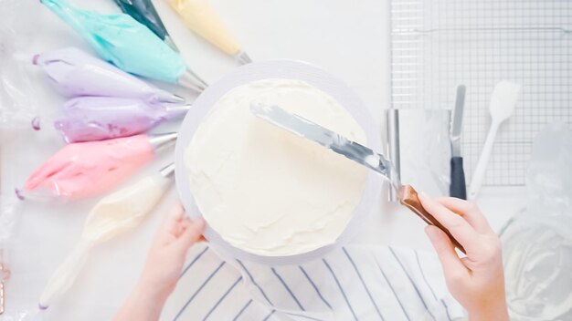 Step by step. Pastry chef making unicorn cake for little girl birthday party.