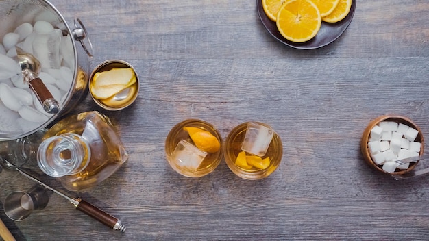 Step by step. Preparing Bourbon old fashioned cocktail at home bar.