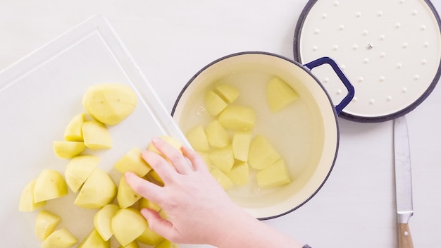Step by step. Preparing classic mashed potatoes for Thanksgiving dinner.