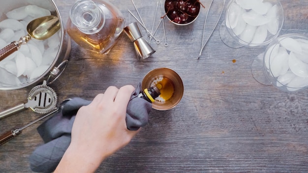 Step by step. Preparing Manhattan cocktail at home bar.