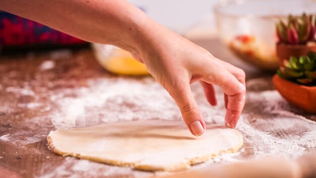 Step by step. Rolling dough for home made empanadas.