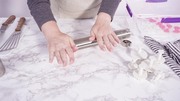 Step by step. Rolling our white fondant on a marble counter.